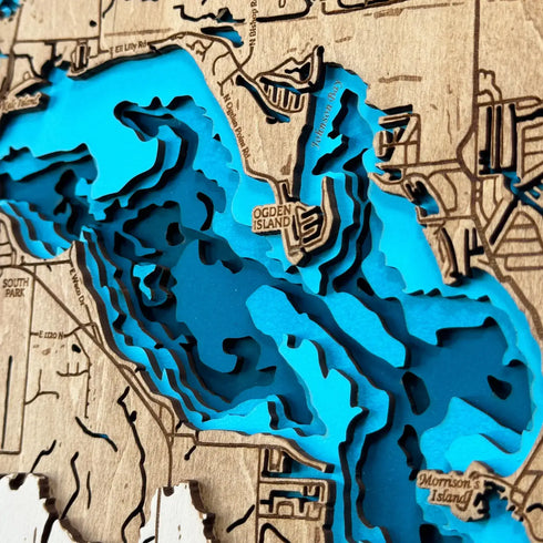 Close-up of layered wood design showing Lake Wawasee depth contours.