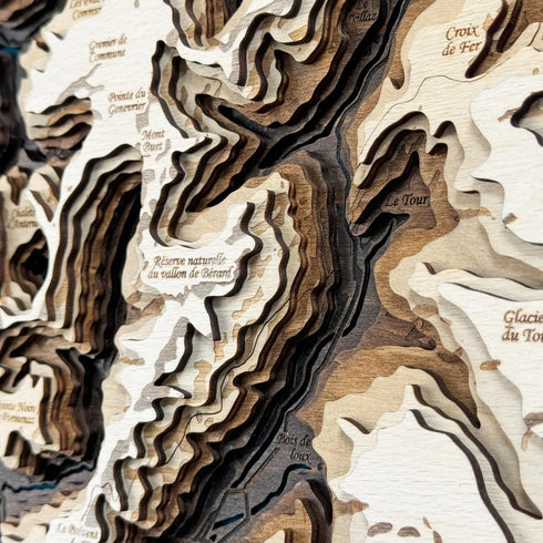 Detailed layered wood engraving of UTMB mountain ridges and valleys.