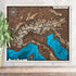 3D wooden map of The Alps with layered mountain contours and snowy peaks