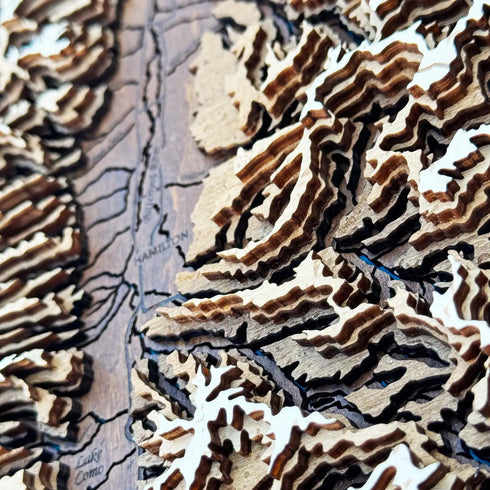 Close-up detail of handcrafted wooden mountain layers on Bitterroot Valley map