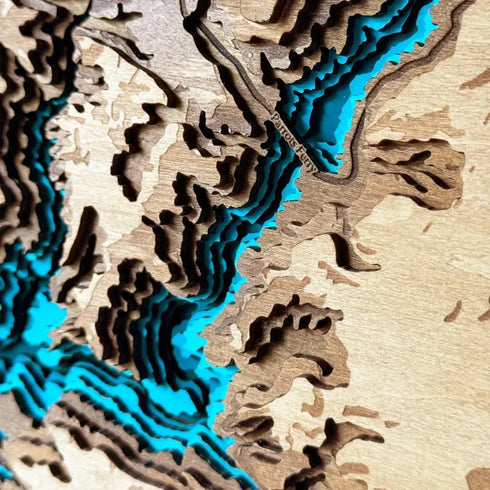 Rustic wooden wall decor showing detailed contour layers of Calaveras County Lake.
