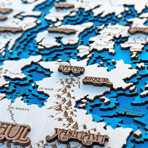 Close-up of Circle of the World 3D wooden map with engraved cities and seas