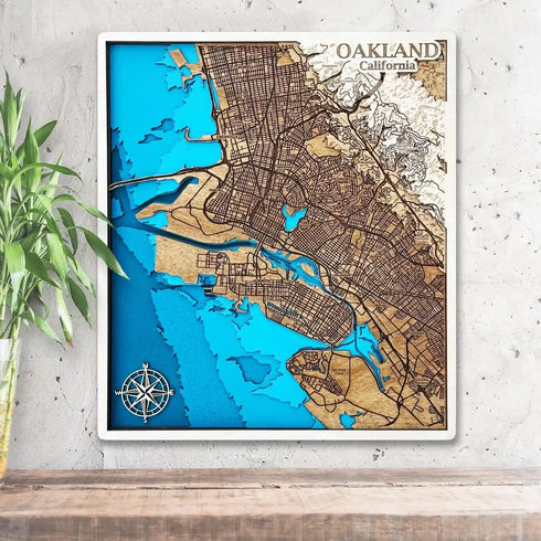 3D wooden map of Oakland, California with blue ocean layers hanging on wall