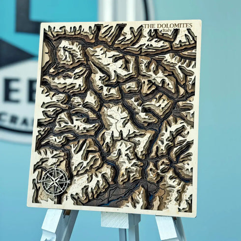 3D layered wooden map of The Dolomites mountains in Italy with detailed topography.