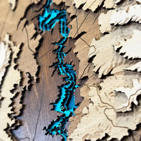 Close-up of laser-cut wooden layers depicting Flaming Gorge shoreline.