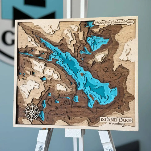 3D wooden topographic map of Island Lake, Wyoming, showing layered contours and compass detail.