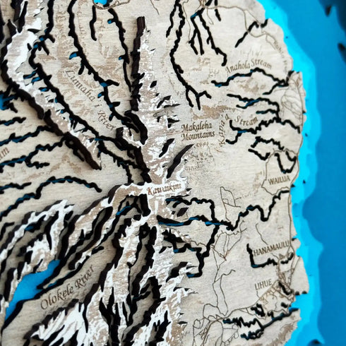 Close-up of Kaua’i wooden map with mountain and canyon layers