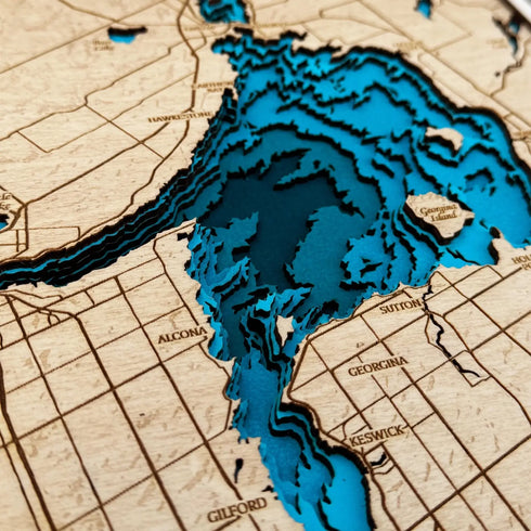 Close-up of Lake Simcoe 3D wooden map with layered water contours