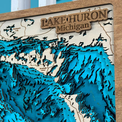 Close‑up of laser‑engraved Lake Huron map with depth contours