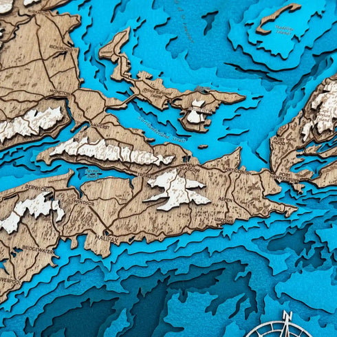 Close up of Nova Scotia 3D wooden map with engraved towns and bays