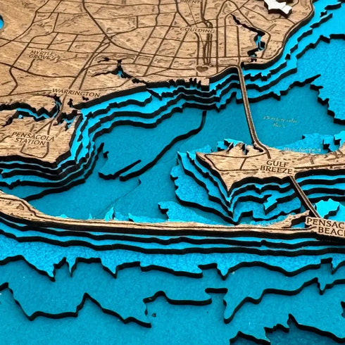 Close up of Pensacola Florida 3D wooden map featuring shoreline and bridges
