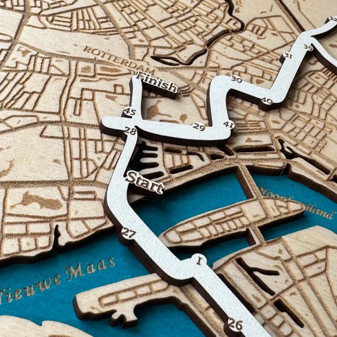 Close-up of Rotterdam Marathon wooden map with engraved start and finish