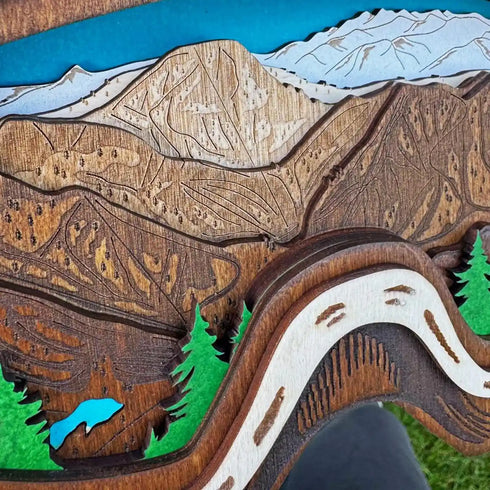 Close up of Sugar Bowl wooden trail map with engraved slopes and alpine trees